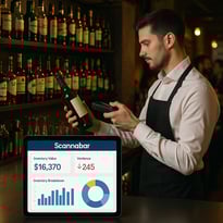 The image showcases a sleek modern bar environment filled with various bottles of liquor neatly arranged on shelves behind the counter A staff member dressed in a crisp white shirt and black apron is seen scanning a bottle with a handheld device high-1